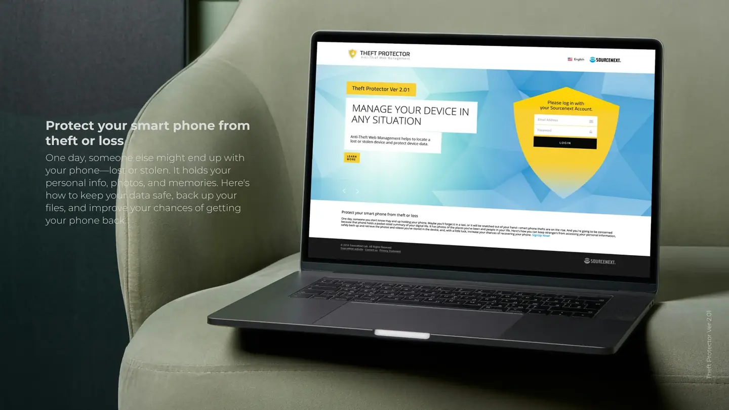 The Theft Protector website on a laptop resting on a green armchair